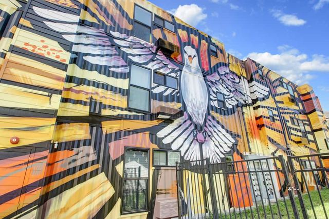 Mural painted across the containers on Ashley Street